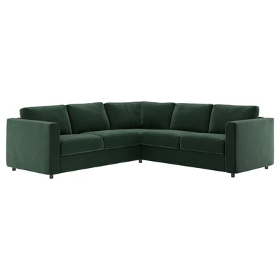 Zielona sofa segmentowa VIMLE z zakrzywionym kształtem litery L i pluszową aksamitną tkaniną.