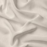 Soft beige sheer curtain fabric, draped elegantly, showcasing delicate weave and light filtering quality.