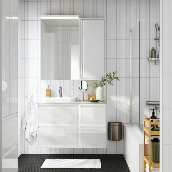 White ÄNGSJÖN vanity set: sleek four-drawer unit with modern sink & mirror.