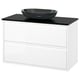 Modern white bathroom vanity, black marble countertop, and glass bowl sink.