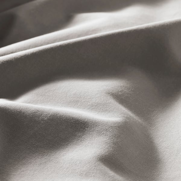 Soft, light gray duvet cover with smooth, even fabric, hinting at a cozy, comfortable texture.