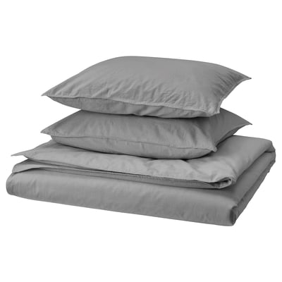 A set of grey, folded bed linens including a duvet cover and two pillowcases, made from 100% cotton.
