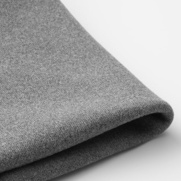Folded gray fabric with textured surface, likely a protective chair cover, shown in close-up.