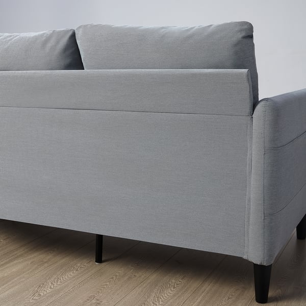 Gray three-seat sofa with side pockets, black legs.