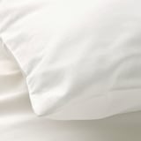 Soft, white organic cotton pillowcase, showcasing smooth texture and fine stitching.
