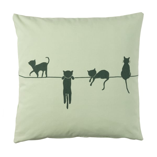 Greenish square pillow with black cat silhouettes walking on a line.