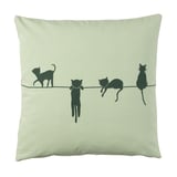 Greenish square pillow with black cat silhouettes walking on a line.