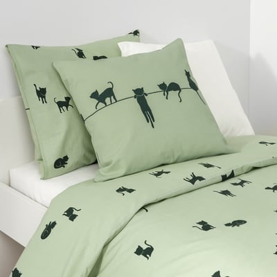 Green bedding with black cat patterns, 2 pillows, fitted sheet.