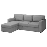 A gray BÅRSLÖV sofa-bed with a chaise longue. It soft shapes and big cushions, perfect for relaxing.