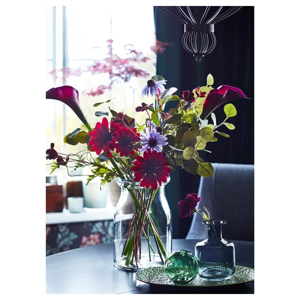 Elegant vase with colorful flowers, glass, clear, cylindrical, dark room, decorative.