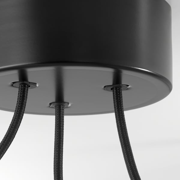 Black metal pendant lamp with three adjustable braided cables. Close-up of ceiling cup detail.