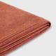 Folded orange-brown recycled polyester fabric, neatly arranged, showcasing its smooth and uniform texture.