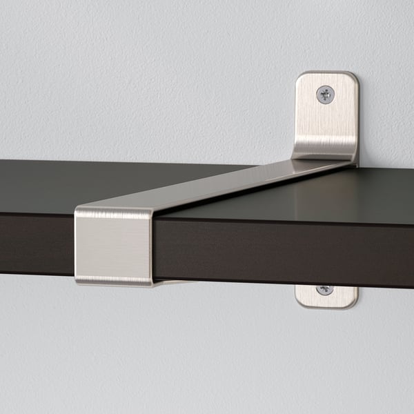 Modern black wall shelf supported by brushed nickel brackets, showing clean lines and secure mounting.