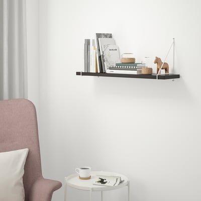 BERGSHULT wall shelf in black, holding books and decor, with sleek edges and steel brackets.