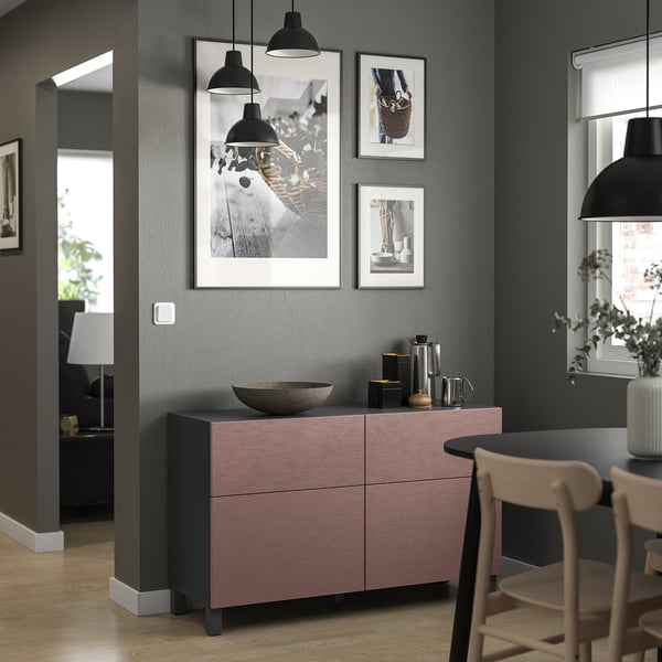 Modern living room with pink-gray BESTÅ sideboard, photos, and black lamps.