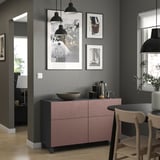 Modern living room with pink-gray BESTÅ sideboard, photos, and black lamps.