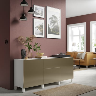 Modern BESTÅ sideboard in room with burgundy walls. Light olive, white side, metallic cabinets, between pendant lights.