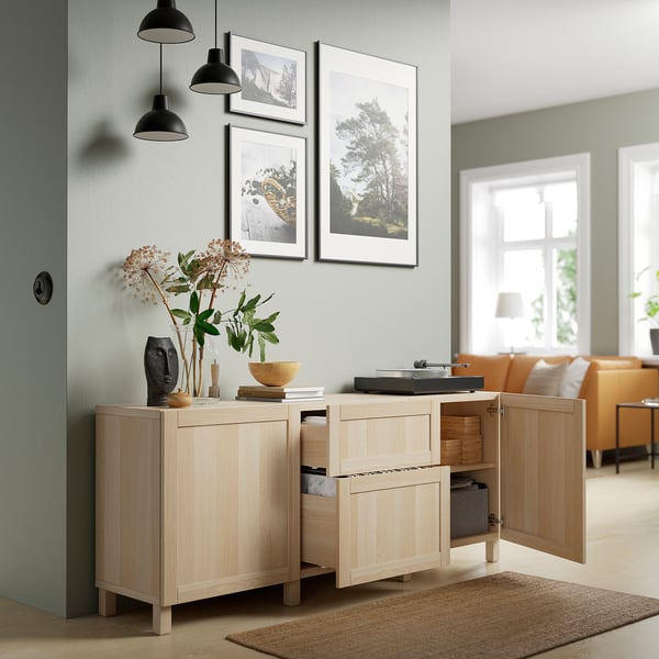 Modern sideboard with open doors reveals adjustable shelves and drawers. Hangs on the wall, offers storage and display space.