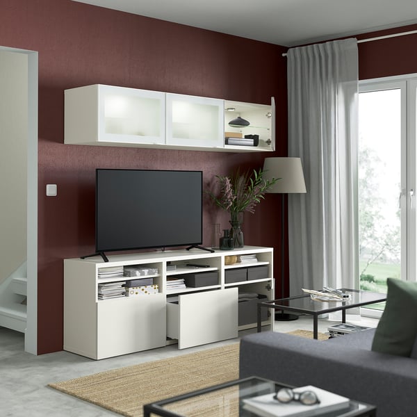 Modern living room with flat screen tv, adjustable shelves, and wall-mounted cabinets.