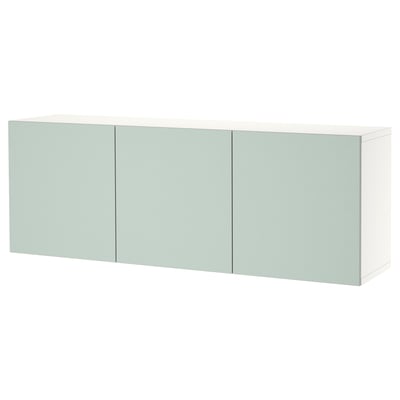 A wall-mounted BESTÅ cabinet in light green with three doors offering storage. Its sleek, minimalist design soft-close hinges.