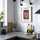 Modern kitchen with orange poster above counter.