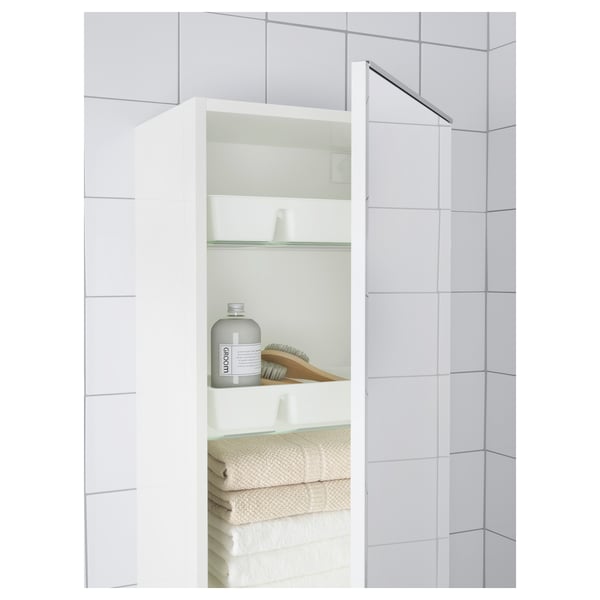 Open vanity unit with folded towels, soap, brush, and lotion.