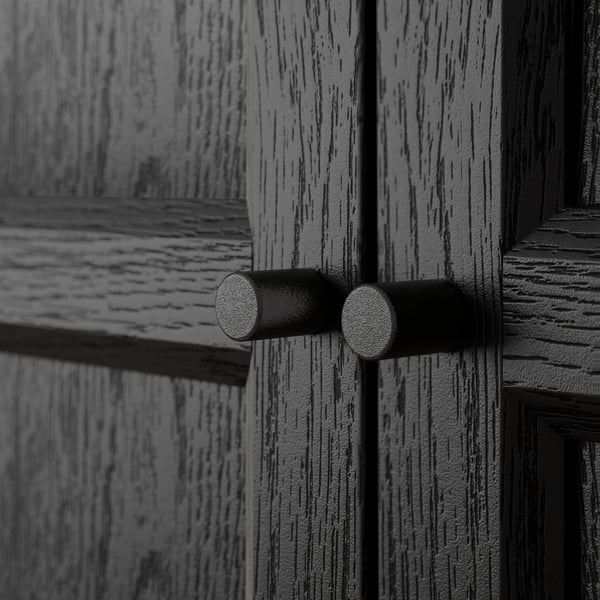 Wooden door close-up with textured, dark metal latch.