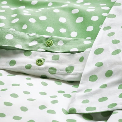 Green dots on white bedding, duvet, plastic closures.