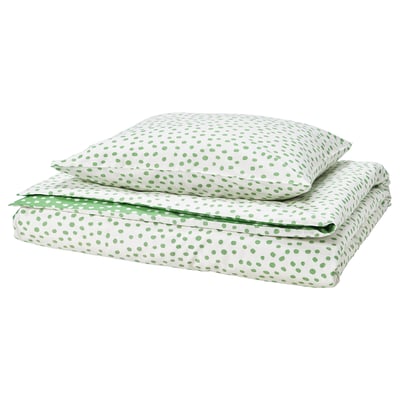 White bedding set with green dots, rectangular shape, smooth fabric, folded neatly.