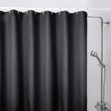 Black BORSTALOE shower curtain made from recycled polyester, featuring a textured waffle design and full-length coverage with chrome fixtures.