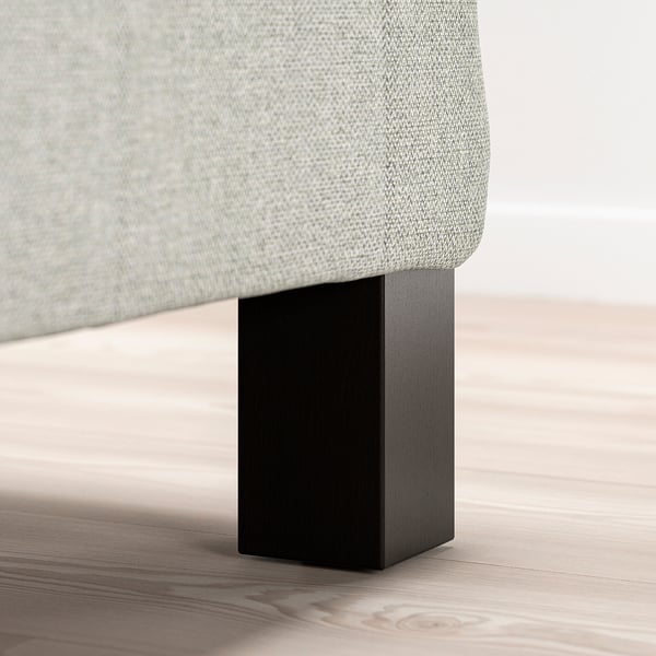 A modern bed leg, black, supportive and stylish.
