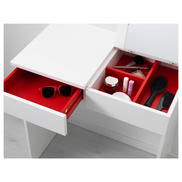 White dresser, red drawers, mirror, storing items.