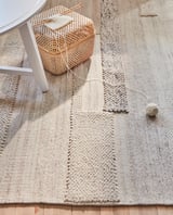 Handwoven BRÖNDEN rug, beige, natural fibers, rectangular, patterned texture.