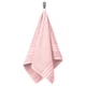 A light pink organic cotton towel hangs neatly from a hook, folded with a woven border design.