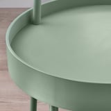 Modern sage-green side table with smooth edges and sturdy handle. Perfect for small spaces, easy to carry.