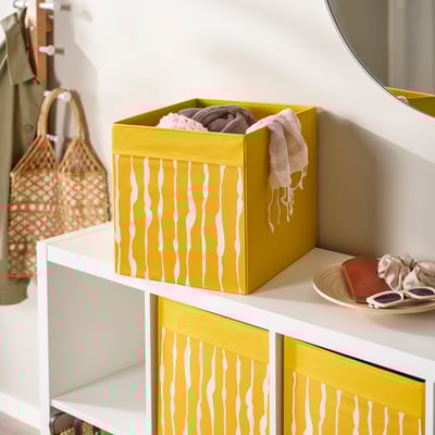 DRÖNA fabric box, yellow with white waves, square shape, for storage and organization.