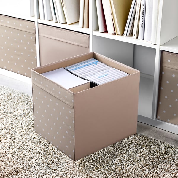 Open beige DRÖNA box with white polka dots on a shelf, holding files, smaller than books.