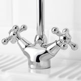 Chrome faucet with cross handles and high spout.