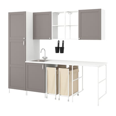 Modern grey modular kitchen with open shelves, closed cabinets, integrated sink, and laundry bags in a sleek design.