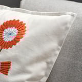 Floral embroidered cushion cover, bright orange flower on white fabric, velvet lumbar pillow, cozy, handcrafted look.