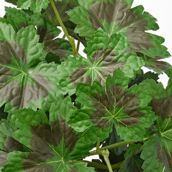 Artificial plant with large, realistic green leaves, meticulously crafted to resemble natural foliage.