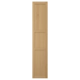 A FORSBACKA kitchen cabinet door in warm oak veneer. It a classic framed design with beveled edges and a natural wood look.