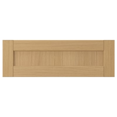 A FORSBACKA drawer front in warm oak wood. Its classic frame design beveled edges.