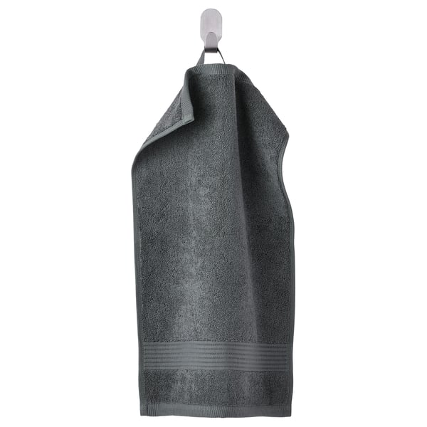 A hanging FREDRIKSJÖN towel in dark gray, made of 100% cotton, with a textured surface and decorative border.