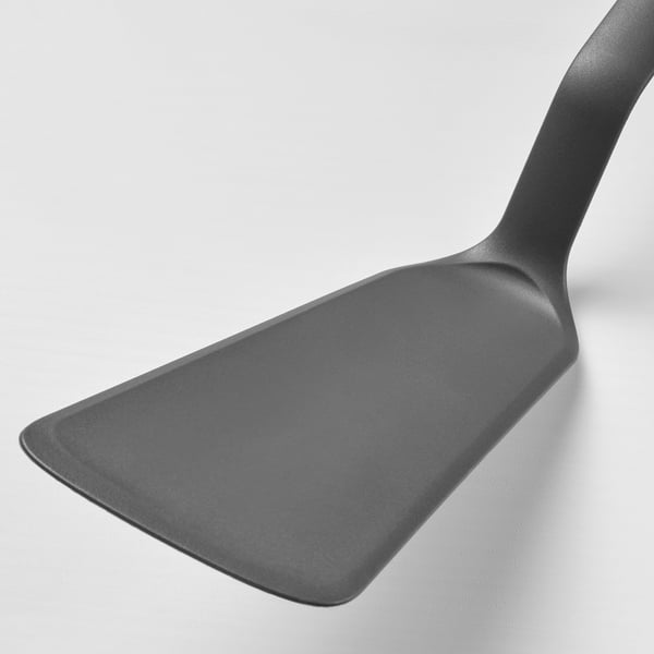 Dark gray, sturdy spatula with smooth edge and comfortable handle, ideal for non-stick cookware.