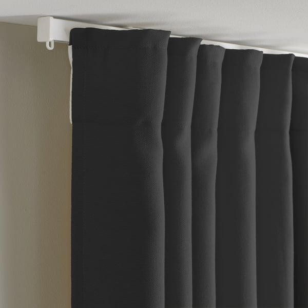 Black curtains with hooks for privacy and light filtering.