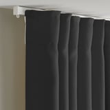 Black curtains with hooks for privacy and light filtering.