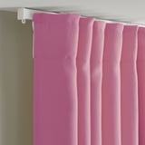 Pink curtains with rod pocket hanging, offering light diffusion and privacy.