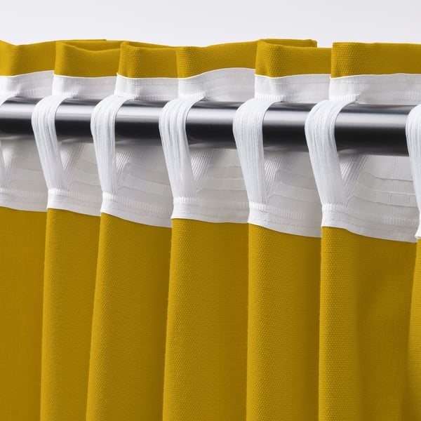Close-up view of yellow curtains with white tab rod pockets for easy hanging, pleated for a formal look.