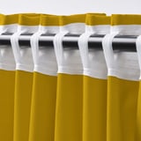 Close-up view of yellow curtains with white tab rod pockets for easy hanging, pleated for a formal look.